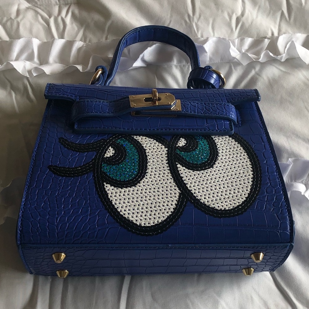Women’s blue mock croc handbag